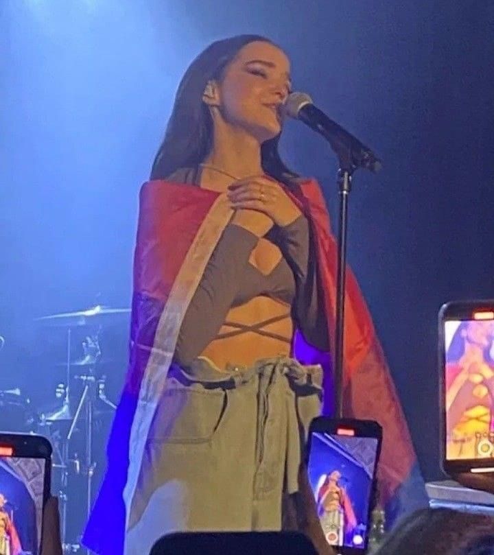 a woman standing on top of a stage holding a microphone