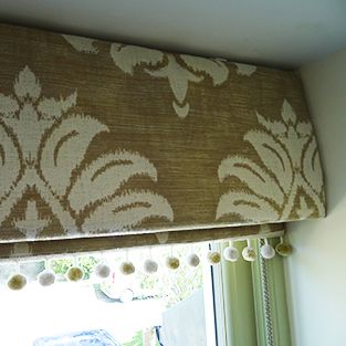 a window with a valance that has flowers on it