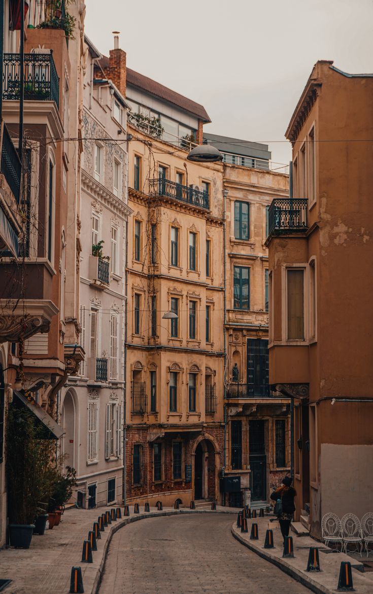 an empty city street lined with tall buildings