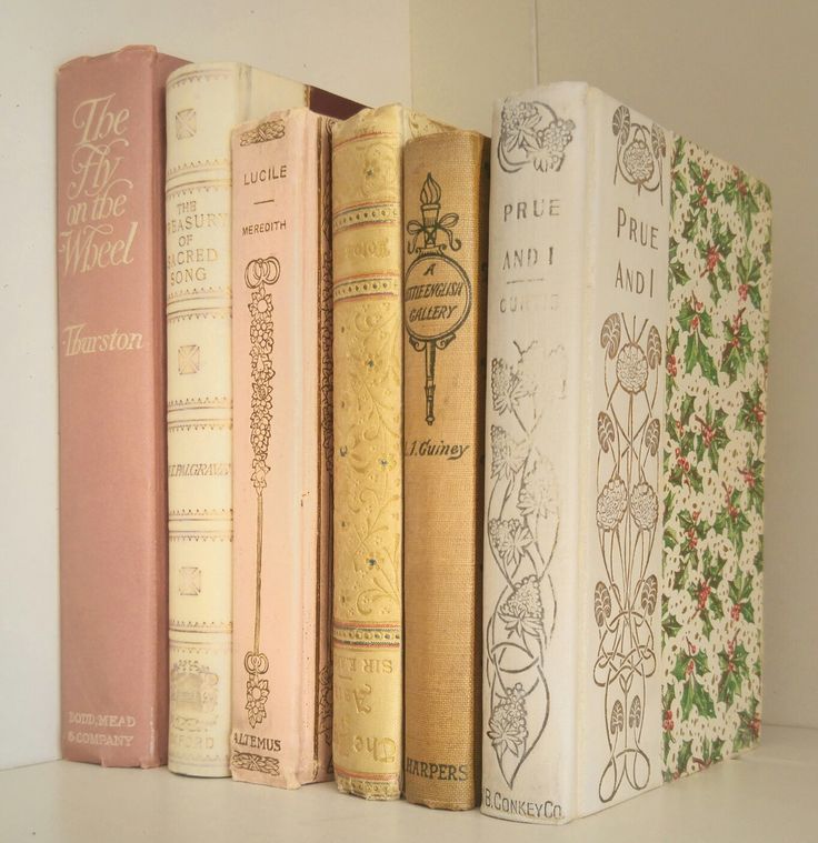 a row of books sitting on top of a white shelf