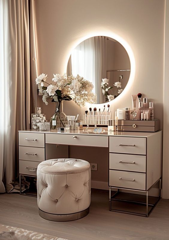 a vanity with a mirror, stool and flowers