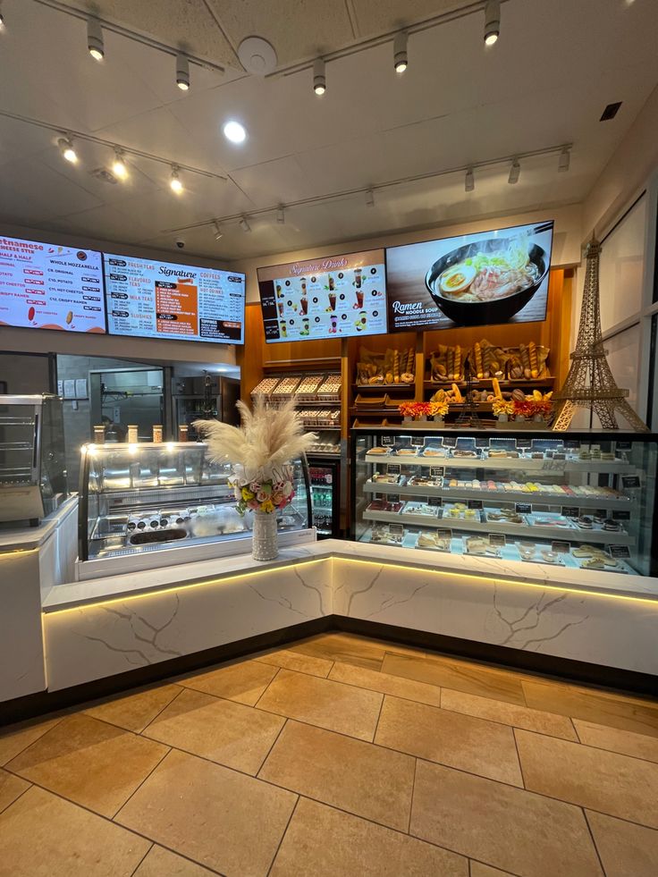 the inside of a restaurant with food on display