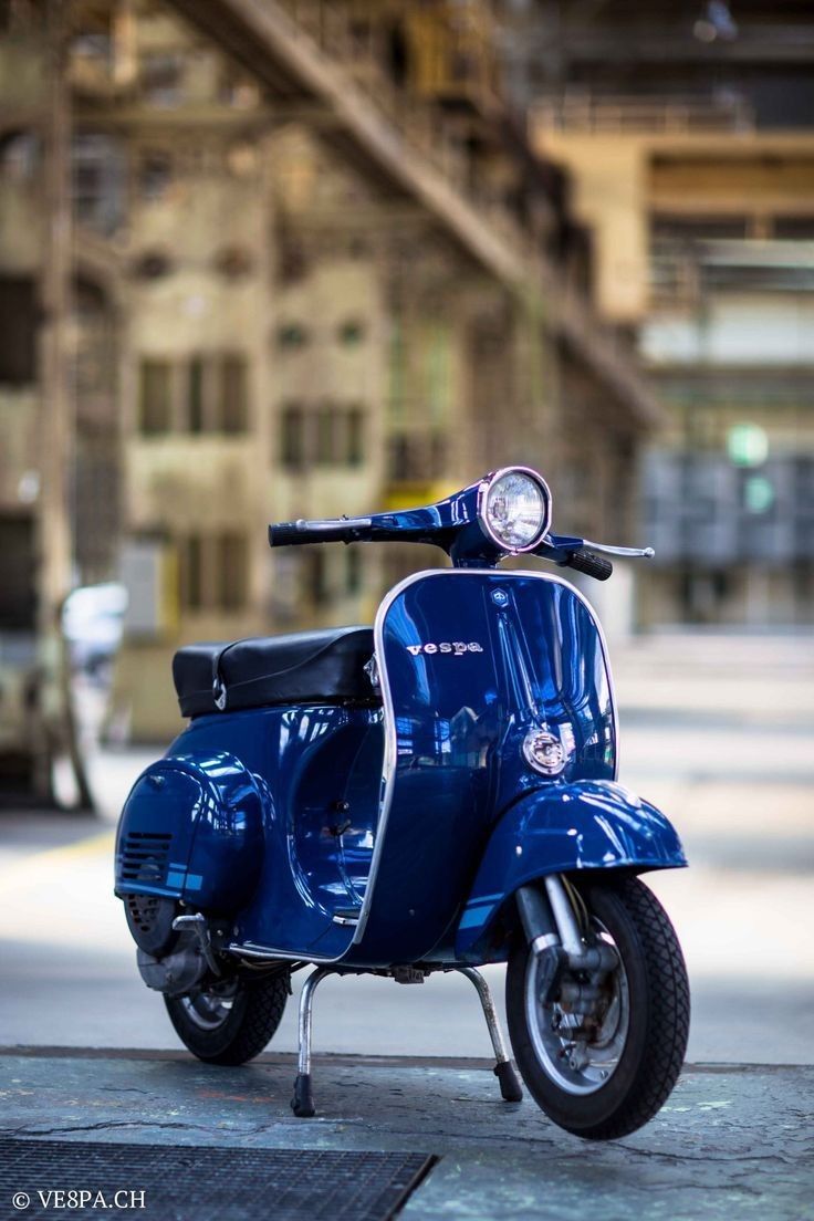 a blue scooter parked in front of a building