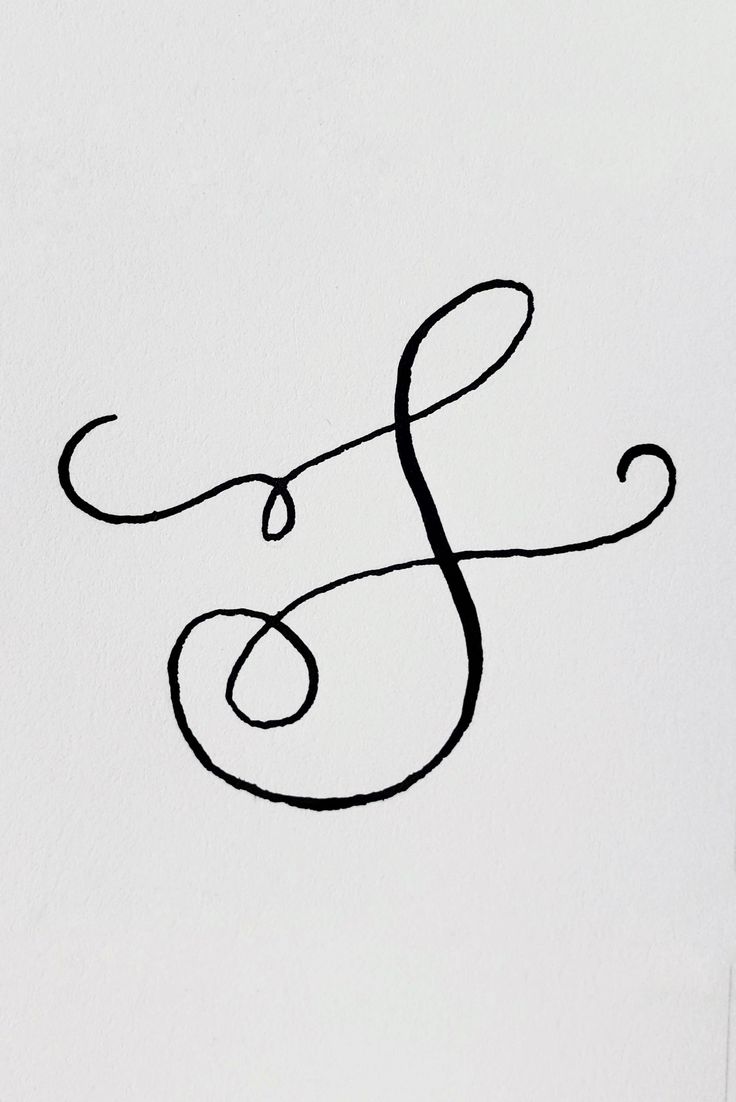 the letter f is written in cursive writing with black ink on white paper