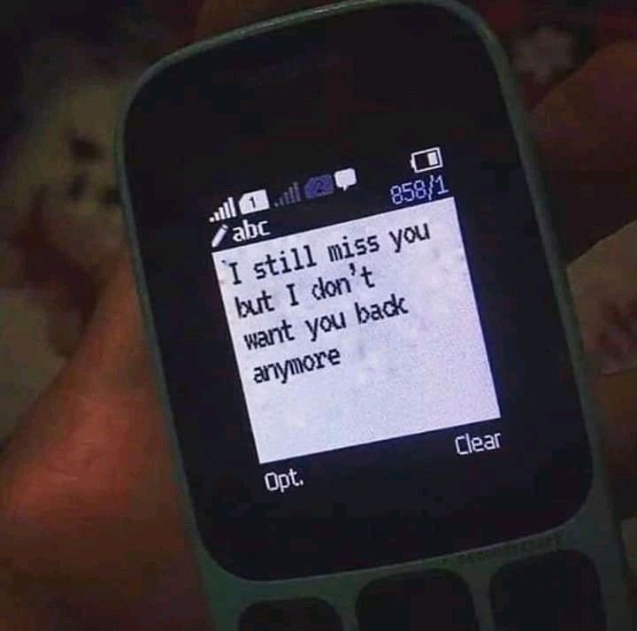 someone is texting on their cell phone with the message i still miss you but i don't want you back anymore