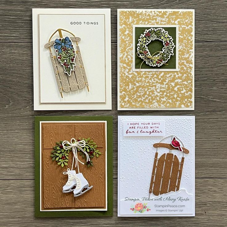 four handmade christmas cards on a wooden table