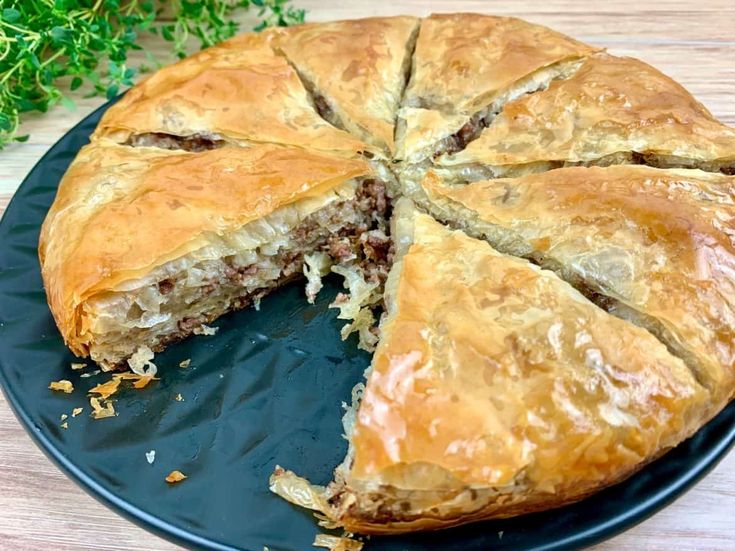 there is a pie that has been cut in half on the plate and ready to be eaten