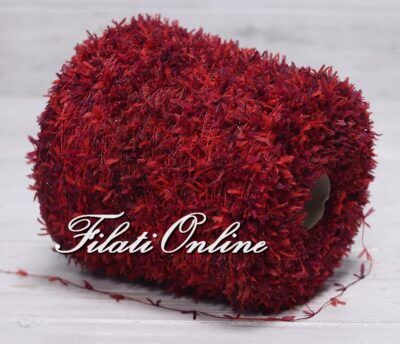 a roll of red yarn sitting on top of a white surface with the word fabric online written across it