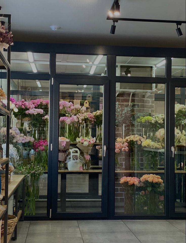 a flower shop filled with lots of different types of flowers