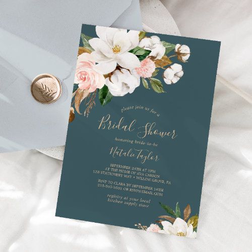 a blue and white floral bridal shower card on top of a bed next to a coin