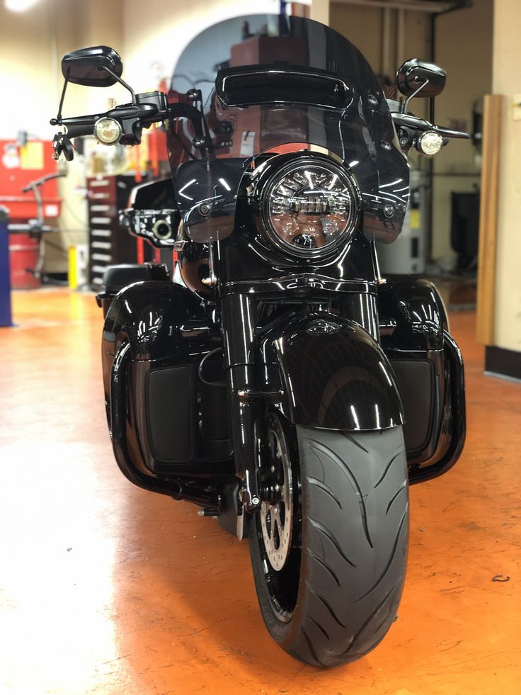 a black motorcycle is parked in a garage