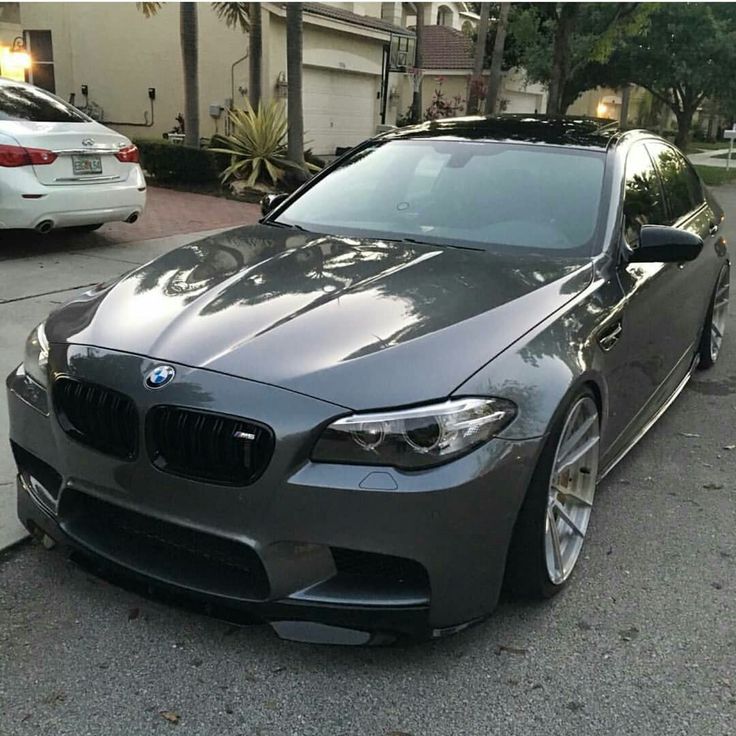 a grey car parked in front of a house