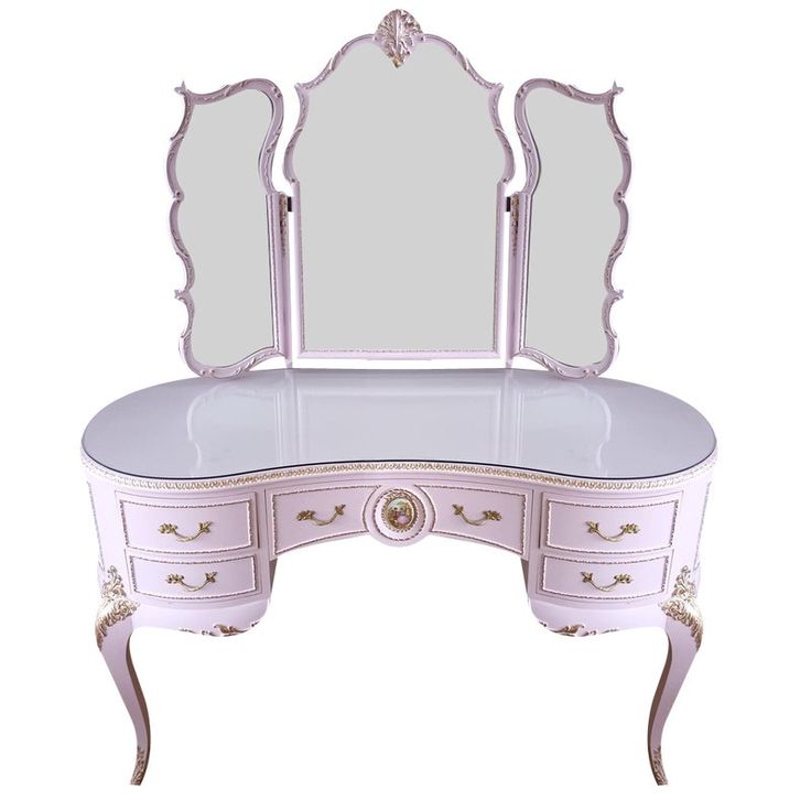 a pink vanity with two mirrors on it