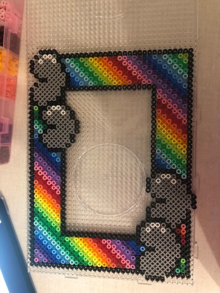 a photo frame made out of legos is shown in the shape of a rainbow