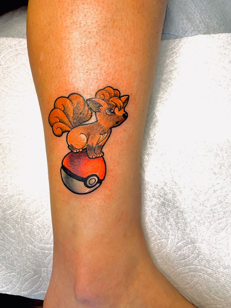 a person with a small tattoo on their leg that has a pokemon pikachu sitting on top of it