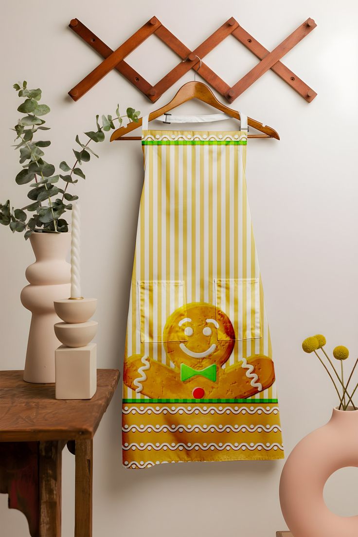 a kitchen towel hanging on a rack next to a potted plant