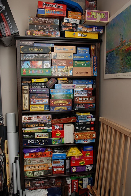 a bookshelf filled with lots of children's books and toys in a room