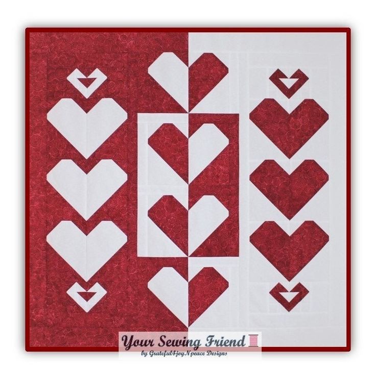 a red and white quilt with hearts on it