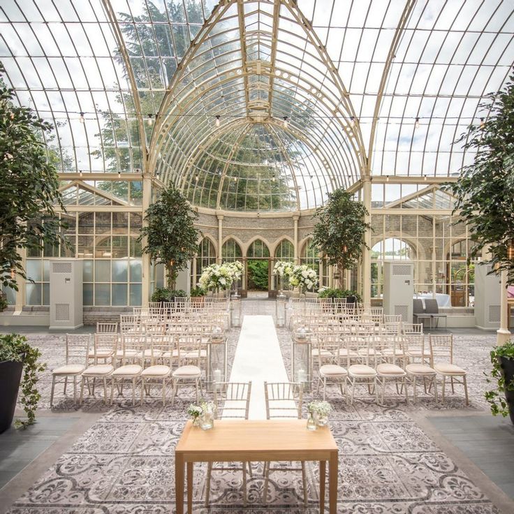 the inside of a building with rows of chairs and tables set up for an outdoor ceremony