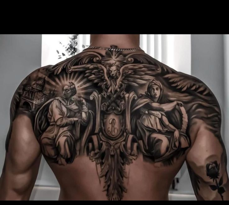 the back of a man with tattoos on his chest