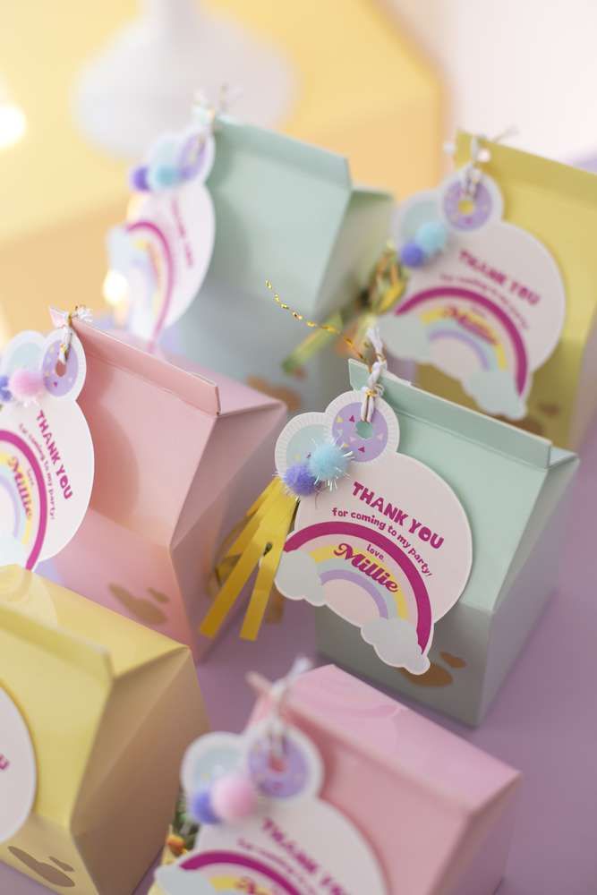 several small gift bags with tags attached to the handles and sides, all decorated in pastel colors