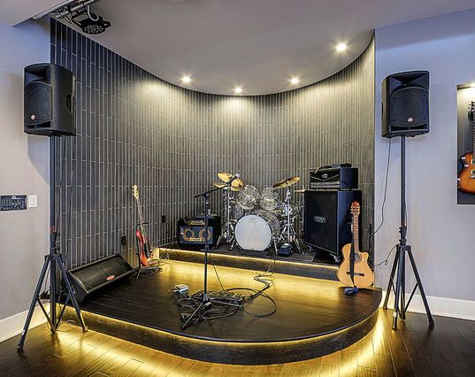 a recording studio with guitars and amps in the background, before and after remodeling