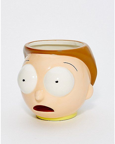 a close up of a ceramic cup with a face on it's head and eyes