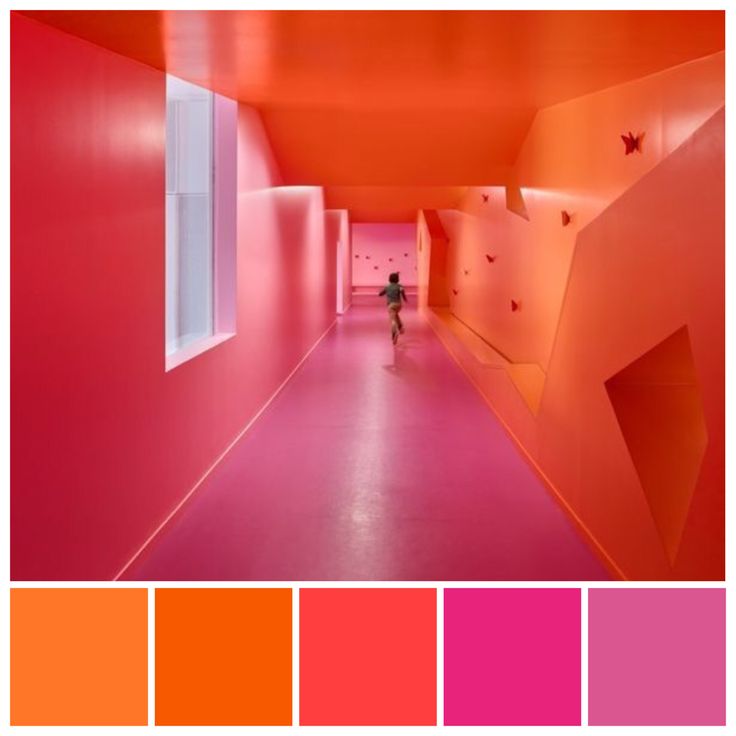 an orange and pink color scheme with a person walking down the hallway