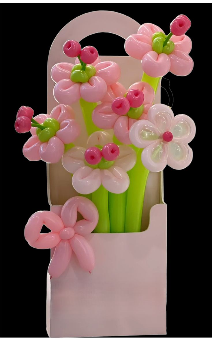 pink and green flowers in a white bag