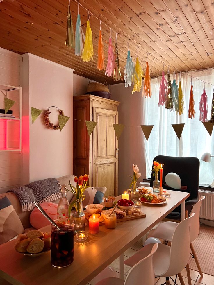 a dining room table is set with food and candles