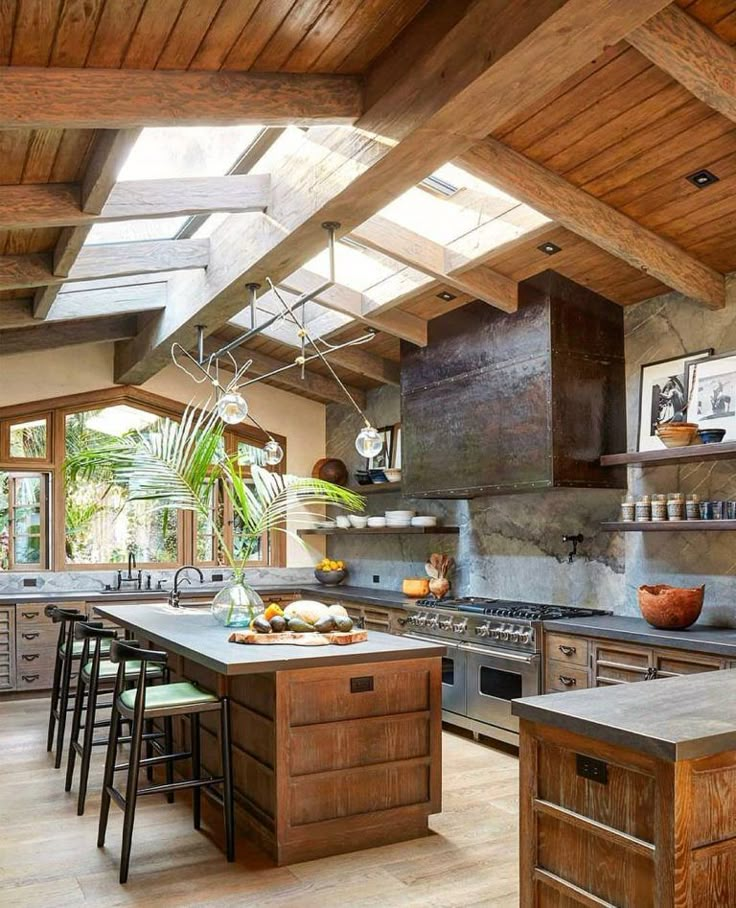 an open kitchen with lots of counter space and skylights above the stove top oven