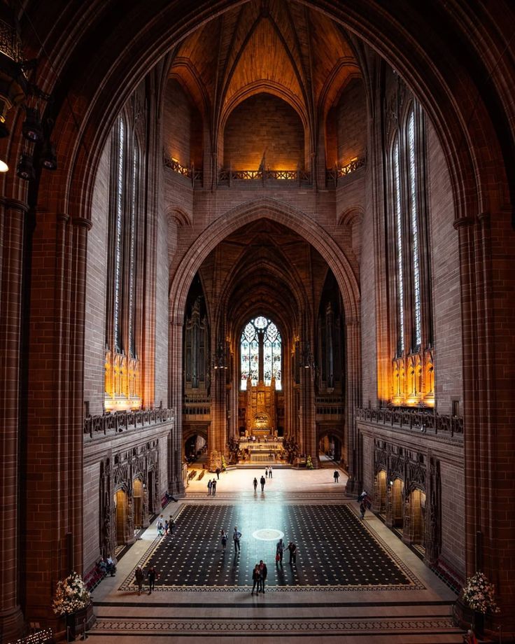 the inside of a cathedral with people walking around