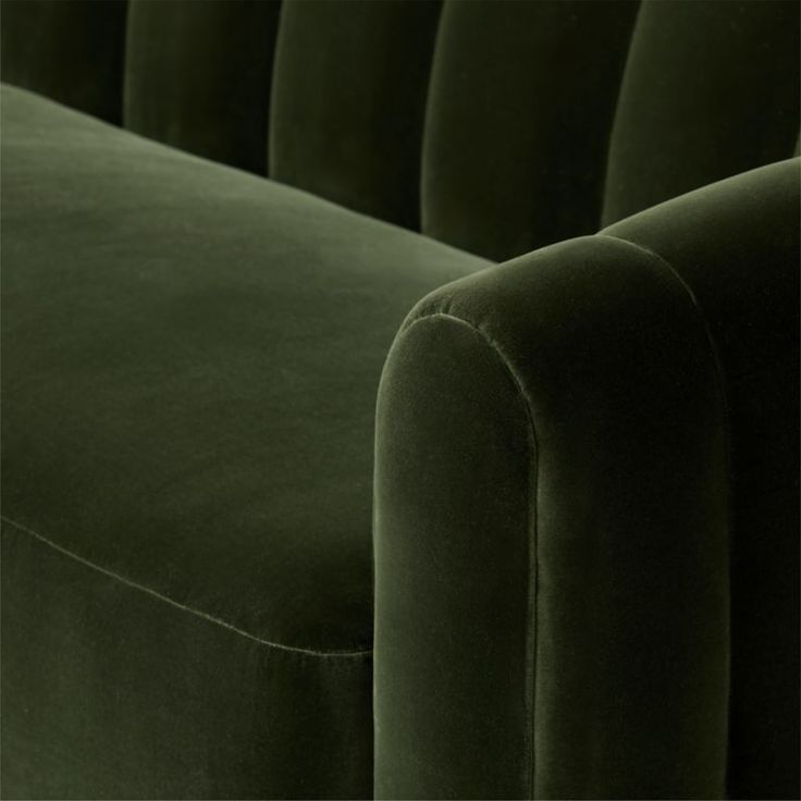 an upholstered green velvet sofa