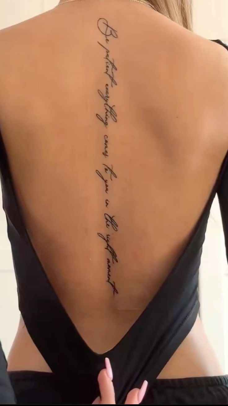 the back of a woman's neck with writing on it