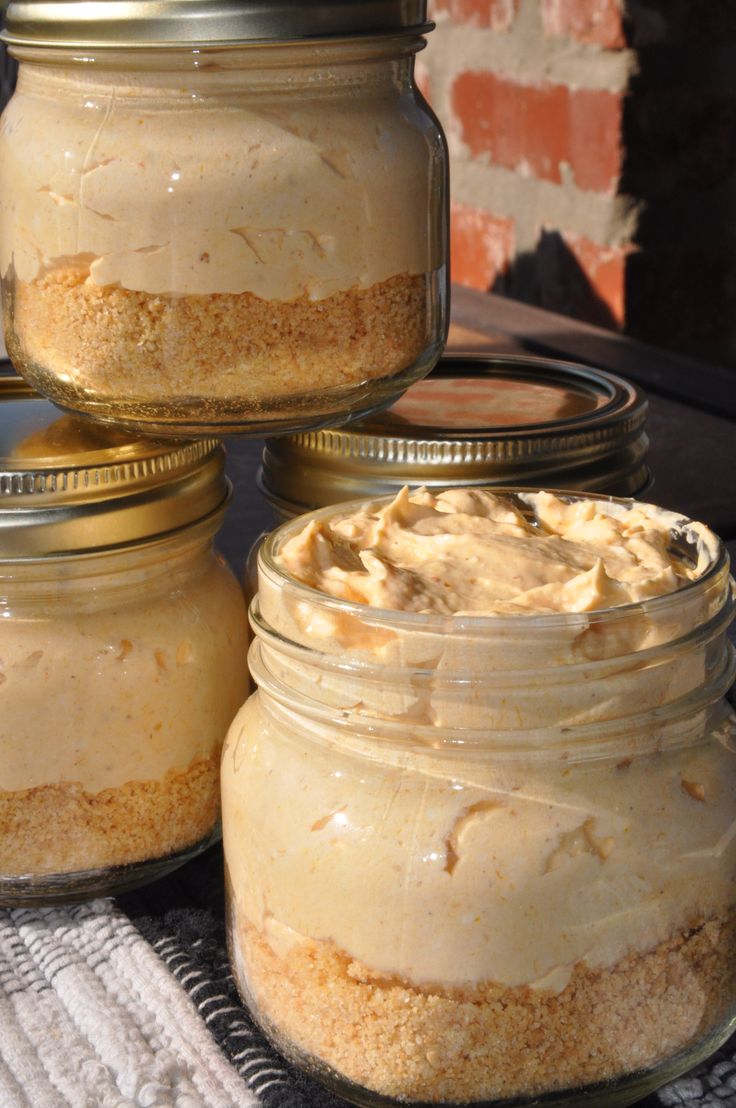 three jars filled with food sitting on top of a table