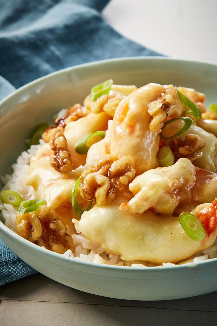 a white bowl filled with food on top of rice