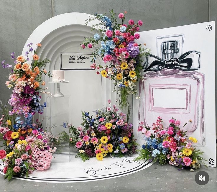 a display with flowers and perfume bottles on it