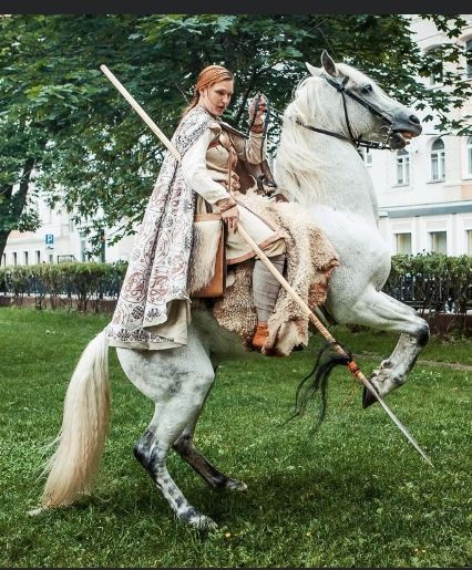 a man riding on the back of a white horse