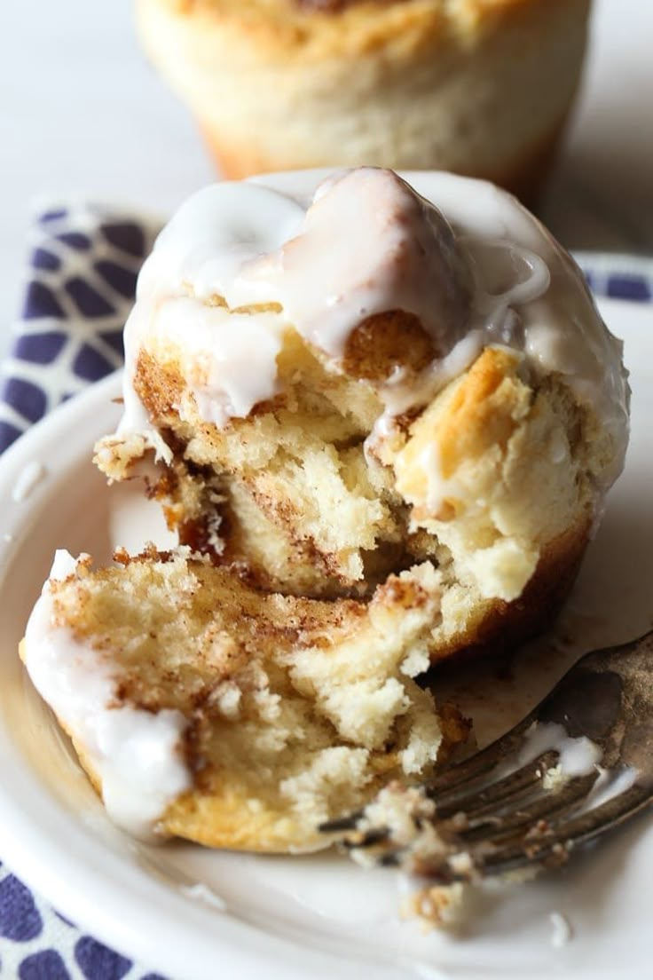 a white plate topped with two cupcakes covered in frosting