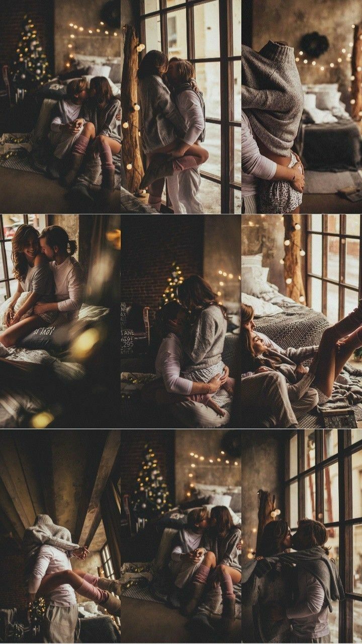 two people sitting on a bed in front of a window with christmas lights around them