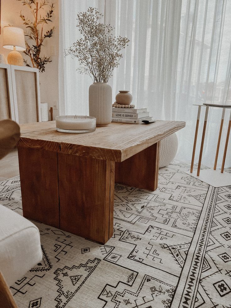 a wooden table sitting on top of a white rug