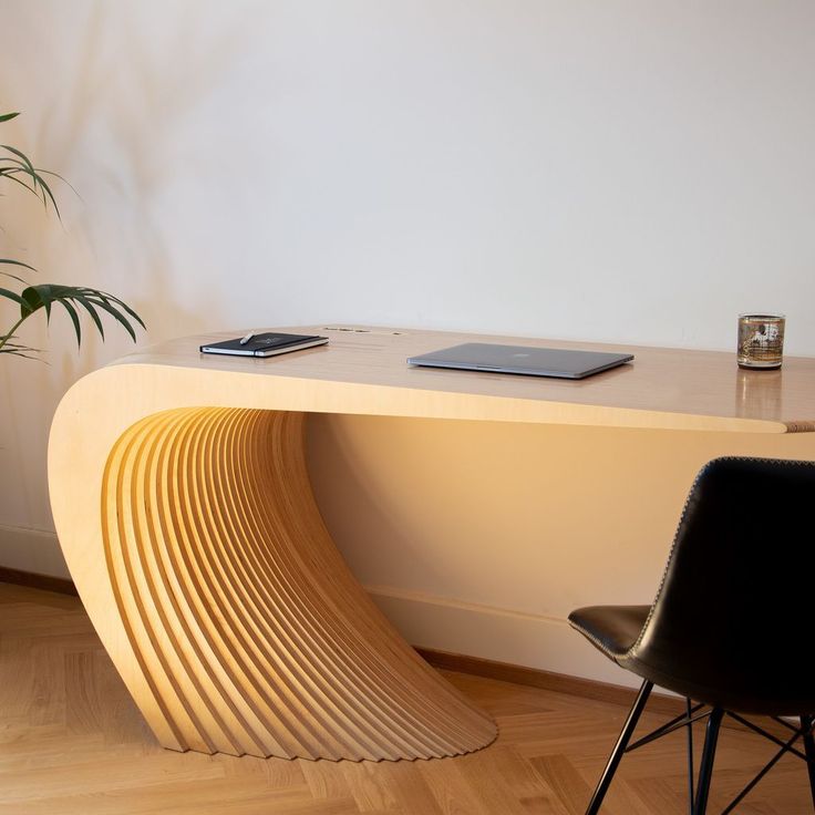 a desk with a phone on it next to a chair