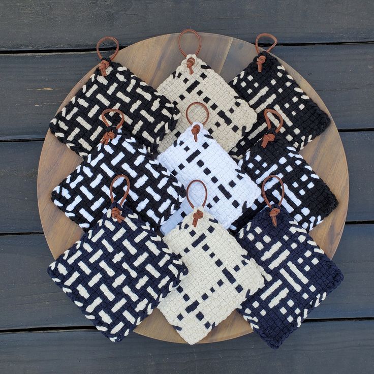 several black and white pieces of cloth on a wooden plate