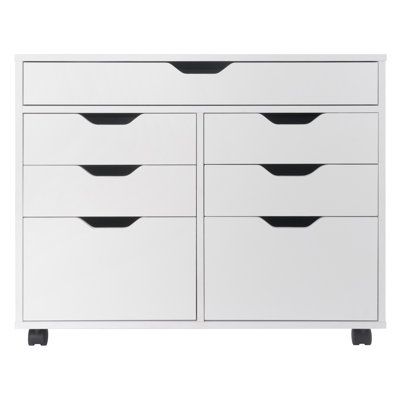 a white dresser with six drawers and black handles