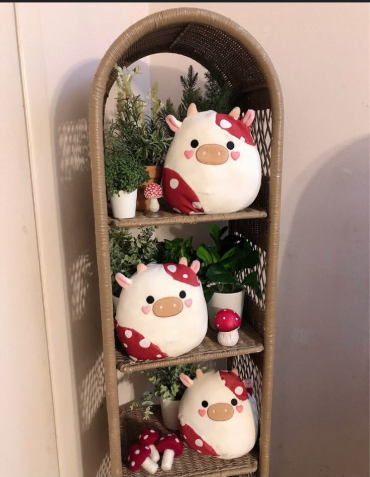 a shelf filled with plants and stuffed animals