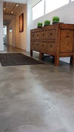 an empty room with two wooden dressers and a rug