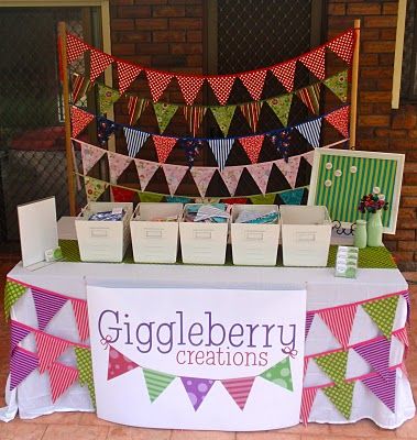 there is a sign that says giggleberry creations on it and some boxes under the banner