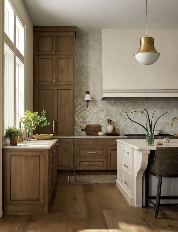 a kitchen with wooden floors and white cabinets