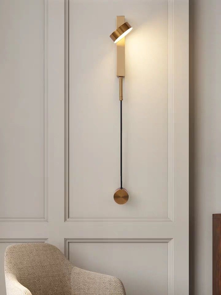 a modern wall light in the corner of a room