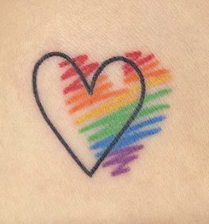 a rainbow heart tattoo on the back of a woman's shoulder with black outline